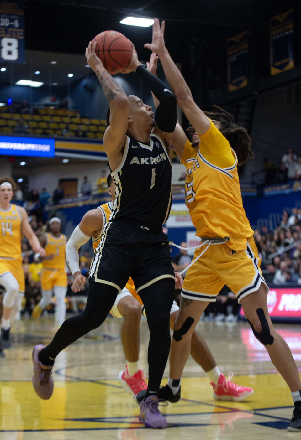 Akron's Shammah Scott takes a shot while being defended by Kent State's Jalen Sullinger during Friday's game.