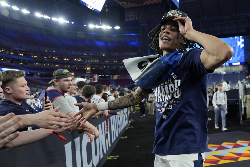 UConn guard Stephon Castle (5) greets fans after their win against Purdue in the NCAA college Final Four championship basketball game, Monday, April 8, 2024, in Glendale, Ariz. (AP Photo/David J. Phillip)