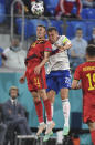 Belgium's Timothy Castagne, left, and Russia's Artem Dzyuba challenge for the ball during the Euro 2020 soccer championship group B match between Russia and Belgium at Gazprom arena stadium in St. Petersburg, Russia, Saturday, June 12, 2021. (AP Photo/Kirill Kudryavtsev, Pool)