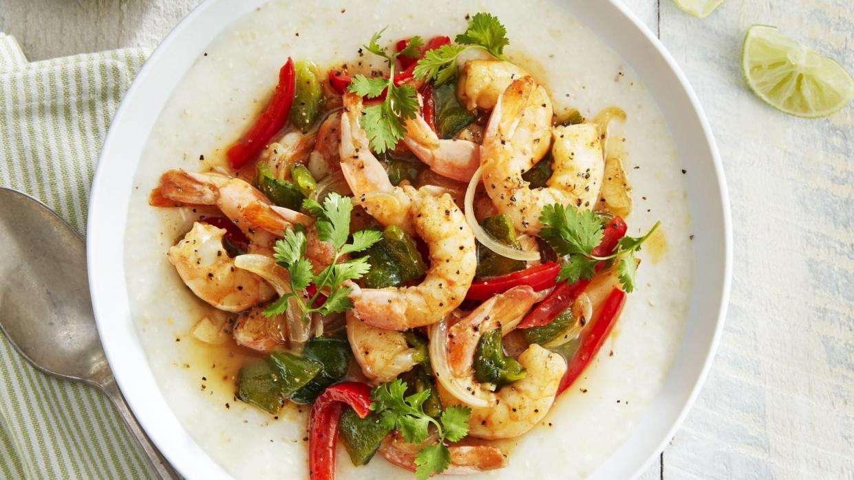 southwest shrimp and grits in a bowl with fresh cilantro and lime wedges