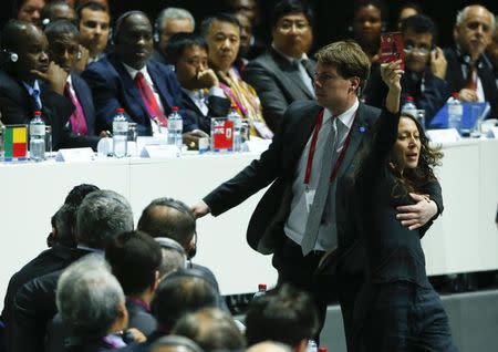 A security officer blocks a pro-Palestine protestor at the 65th FIFA Congress in Zurich, Switzerland, May 29, 2015. REUTERS/Ruben Sprich