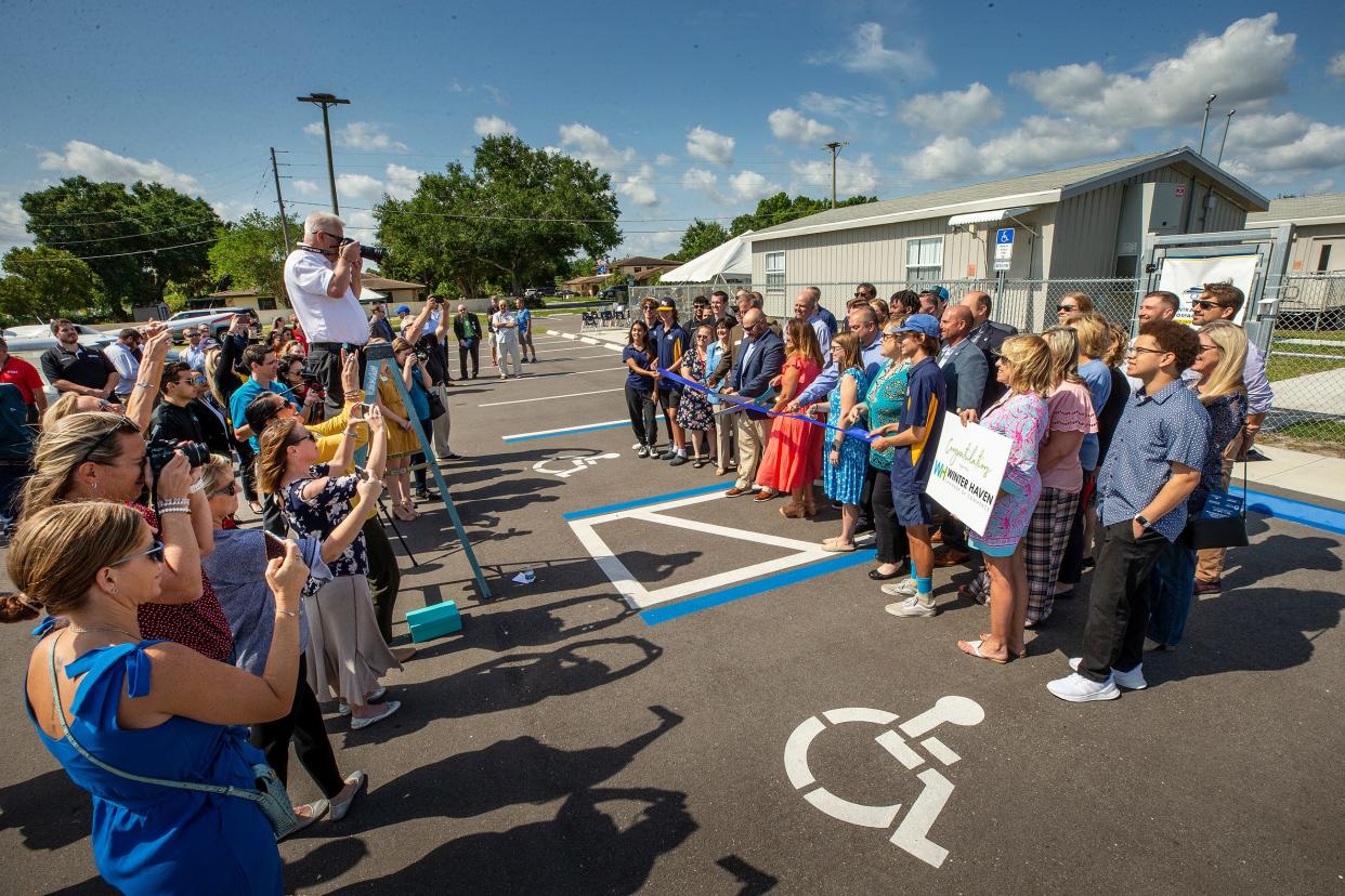 Students and officials attend a ribbon-cutting for the new Central Florida Aerospace Academy-Winter Haven Senior High School at Winter Haven Regional Airport on Wednesday.