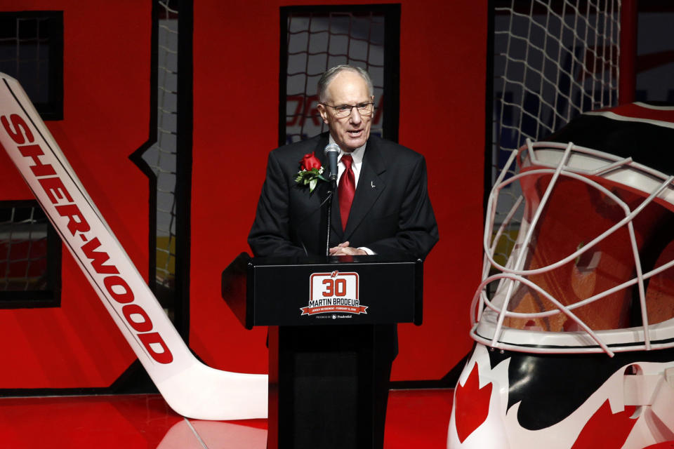 FILE - In this Feb. 9, 2016, file photo, Michael "Doc" Emrick, American network television play-by-play sportscaster and commentator noted mostly for his work in ice hockey, talks about former New Jersey Devils star goalie Martin Brodeur at the Prudential Center arena as the Devils retire Brodeur's number 30 jersey, in Newark, N.J. Hall of Fame hockey broadcaster Mike Emrick is retiring after a career of almost 50 years behind the microphone, including the past 15 as the voice of the NHL in the United States. (AP Photo/Mel Evans, File)