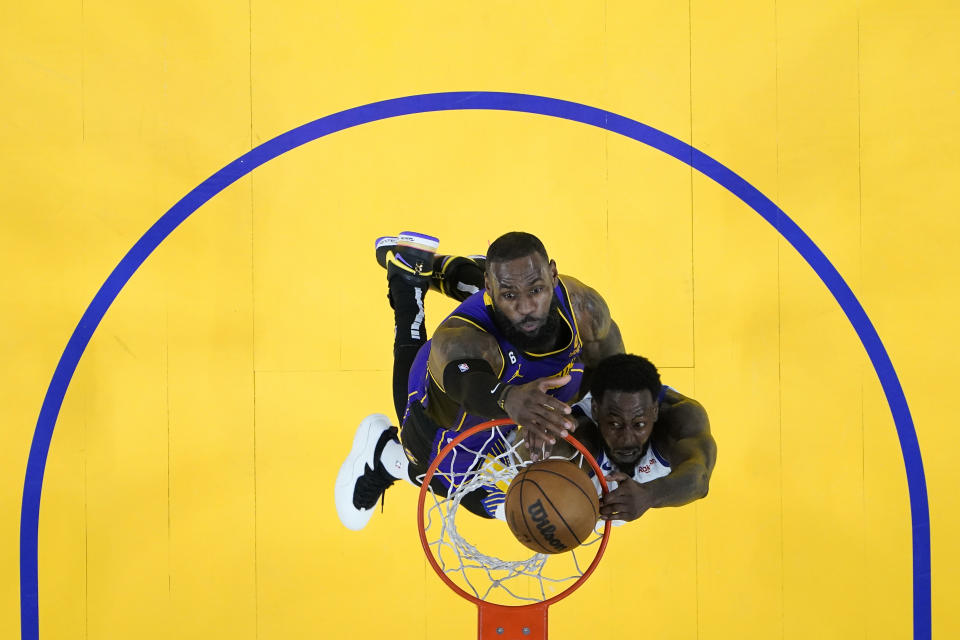 Golden State Warriors forward JaMychal Green goes up for a shot while defended by Los Angeles Lakers forward LeBron James, back, during the second half of Game 2 of an NBA basketball Western Conference semifinal game, Thursday, May 4, 2023, in San Francisco. (AP Photo/Godofredo A. Vásquez)