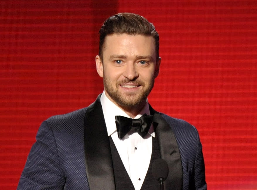 FILE - In this Nov. 24, 2013 file photo, Justin Timberlake accepts the award for favorite album - soul/R&B for "The 20/20 Experience" at the American Music Awards in Los Angeles. In the Coen brothers’ “Inside Llewyn Davis” Timberlake plays a supporting role as a cheery, sweater-wearing 1960s folk musician. But he also collaborated with producer T Bone Burnett on the movie’s memorable period songs and helped shape the film’s most unforgettable and comic tune, “Please Mr. Kennedy.” (Photo by John Shearer/Invision/AP, File)