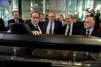 French President Francois Hollande (R) poses besides naval shipbuilder DCNS CEO Herve Guillou (3rdR), Defence Minister Jean-Yves Le Drian (2ndL) and Interior Minister Bernard Cazeneuve during a visit at the DCNS heaquarters in Paris, France, April 26, 2016 after they won the deal to build a fleet of 12 submarines for Australia. REUTERS/Christophe Petit-Tesson/Pool