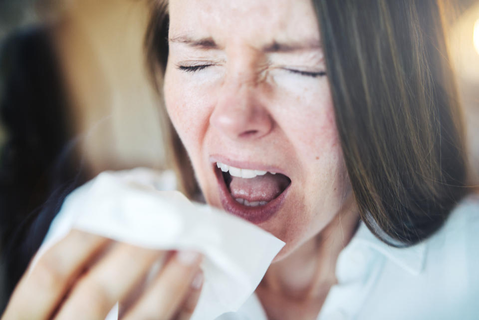 a woman sneezing