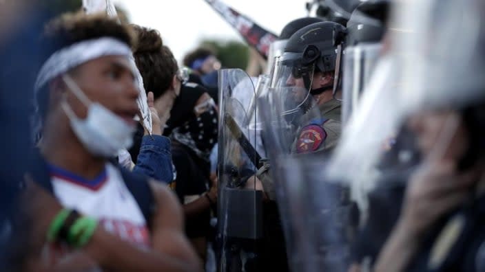 Demonstrators face members of the Austin Police Department as they gather in downtown Austin, Texas in June 2020 to protest the death of George Floyd. The Austin City Council approved paying a combined $10 million to two people injured when officers fired beanbag rounds into crowds. (Photo: Eric Gay/AP)