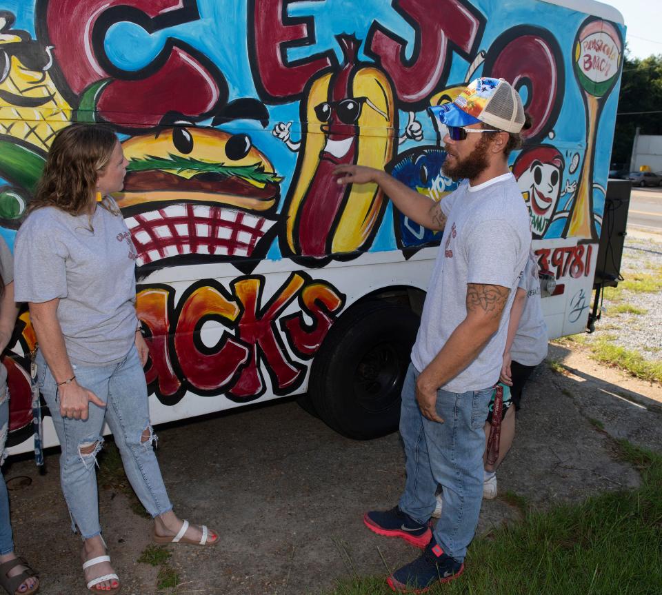 Andre Johns, the owner of the CEJO food truck, describes his inspiration for the new CEJO's Corner eatery in Milton to co-owner Toriee Nielsen on Aug. 2, 2023. 