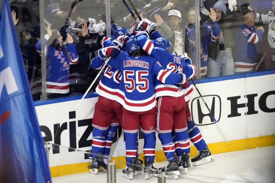 The New York Rangers celebrate after center Mika Zibanejad scored a goal against the New Jersey Devils during the second period of an NHL hockey game, Saturday, April 29, 2023, at Madison Square Garden in New York. (AP Photo/Mary Altaffer)