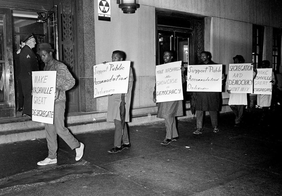 John Lewis, national chairman of the Student Non-Violent Coordinating Committee, second from left, marches with other students in Nashville.