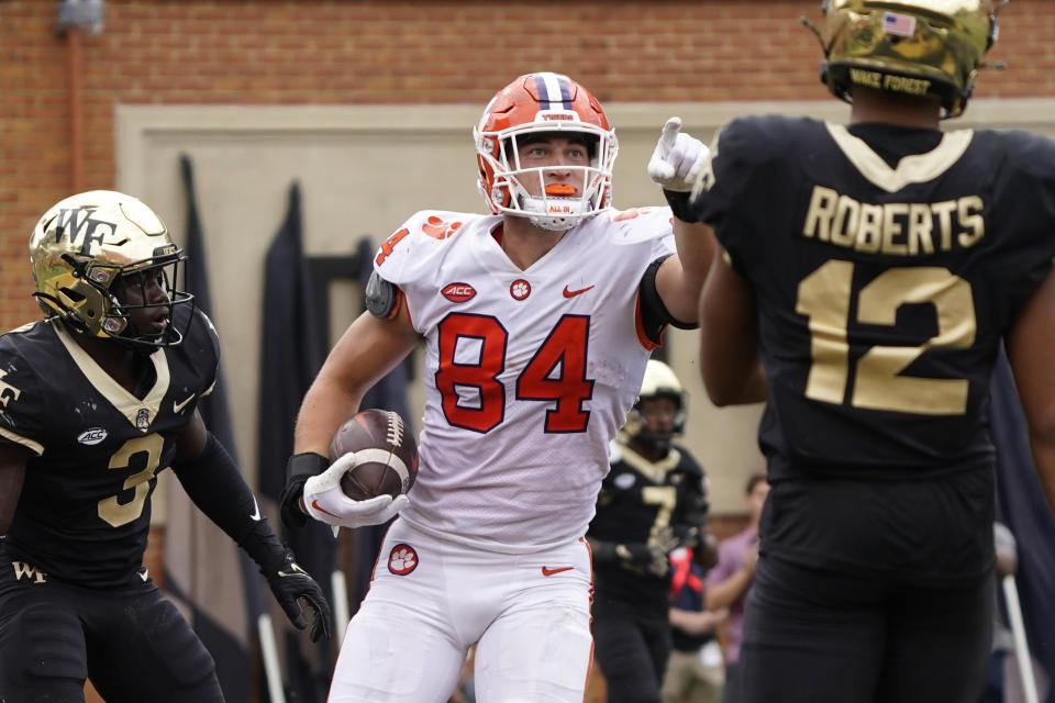 Clemson tight end Davis Allen (84) celebrates his touchdown catch against Wake Forest defensive back Malik Mustapha (3) during the second overtime of an NCAA college football game in Winston-Salem, N.C., Saturday, Sept. 24, 2022. Clemson won 51-45 in double overtime. (AP Photo/Chuck Burton)