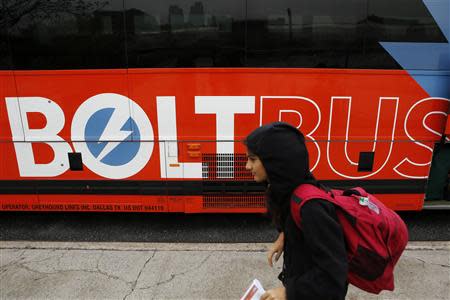 A woman walks past a Boltbus bus in New York City May 8, 2014. REUTERS/Eduardo Munoz