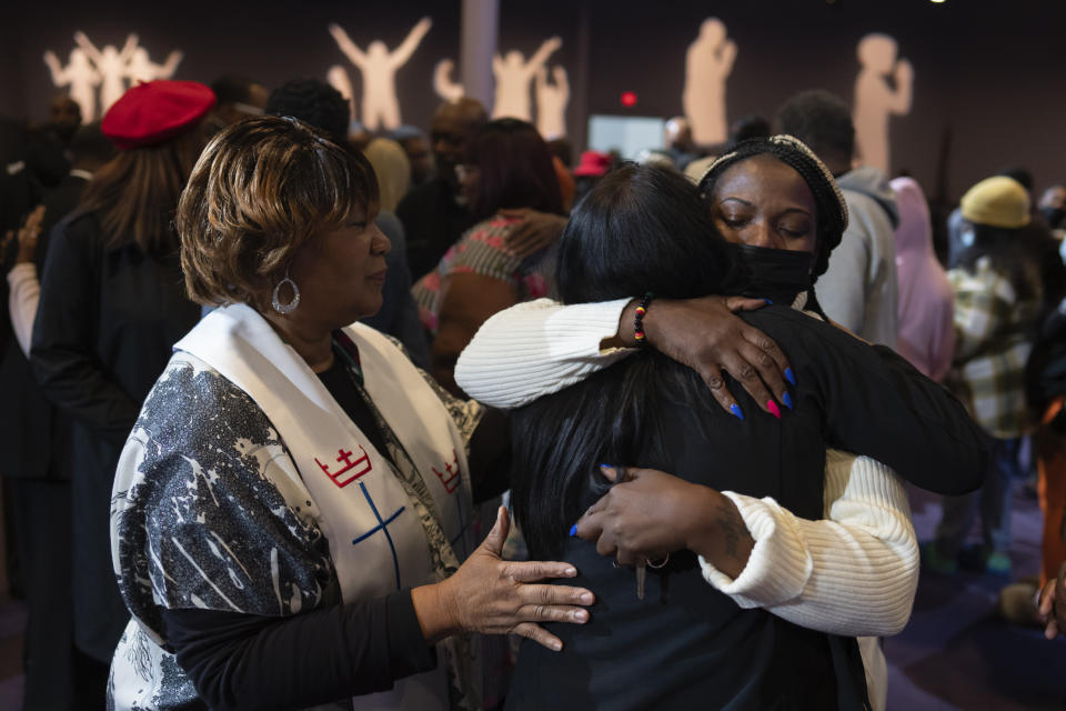 Sonya Johnson, the aunt of Tyneka Johnson, 22, of Portsmouth, Va., right in the white sweater, hugs Carmen Kingston, a loved one of Fernando "Jesus" Chavez-Barron, 16, of Chesapeake, Va., during a prayer vigil held by the Chesapeake Coalition of Black Pastors at The Mount (Mount Lebanon Baptist Church) in Chesapeake, Va., Sunday, Nov. 27, 2022, for the six people killed at a Walmart in Chesapeake, Va., including Tyneka Johnson and Chavez-Barron, when a manager opened fire with a handgun before an employee meeting Tuesday night. (AP Photo/Carolyn Kaster)