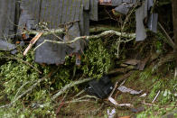 A television is seen among the debris of a crushed house in the aftermath of a mudslide that destroyed three homes on a hillside in Sausalito, Calif., Thursday, Feb. 14, 2019. Waves of heavy rain pounded California on Thursday, filling normally dry creeks and rivers with muddy torrents, flooding roadways and forcing residents to flee their homes in communities scorched by wildfires. (AP Photo/Michael Short)
