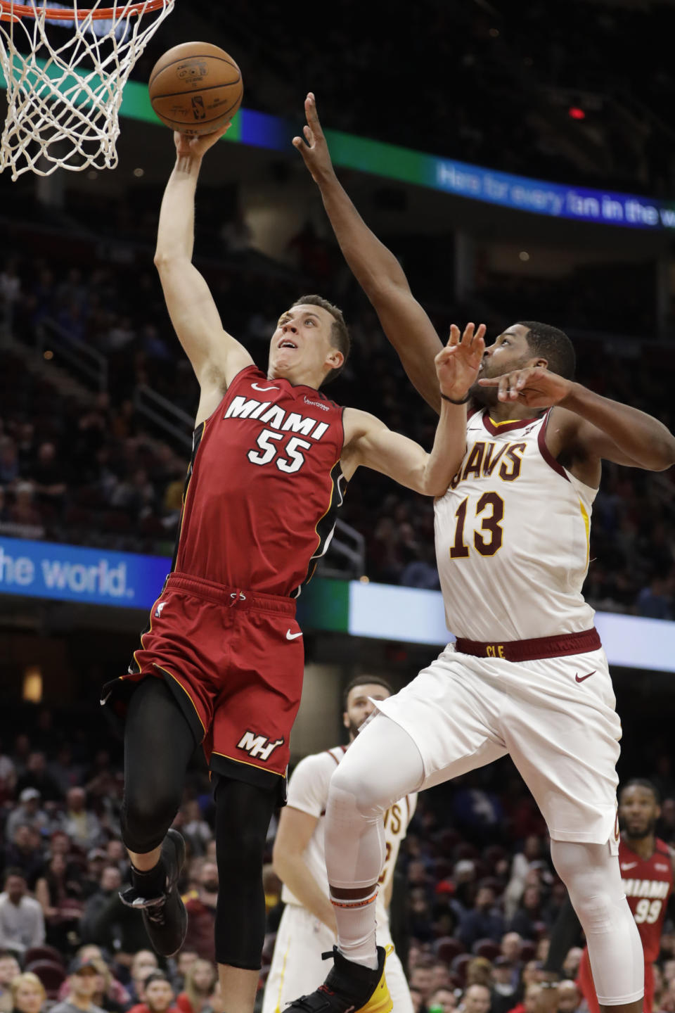 Miami Heat's Duncan Robinson (55) drives against Cleveland Cavaliers' Tristan Thompson (13) in overtime of an NBA basketball game, Monday, Feb. 24, 2020, in Cleveland. (AP Photo/Tony Dejak)