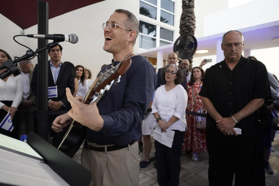 Cantor Juval Porat performs during an empty Shabbat table event honoring those kidnapped by Hamas in Israel, Thursday, Nov. 2, 2023, at Temple Beth Sholom in Miami Beach, Fla. The holiday of Hanukkah, Judaism's festival of lights, will be both more needed and more poignant than ever this year, say Jews from across the religious observance and political spectrum in Miami Beach and neighboring South Florida communities. (AP Photo/Wilfredo Lee)