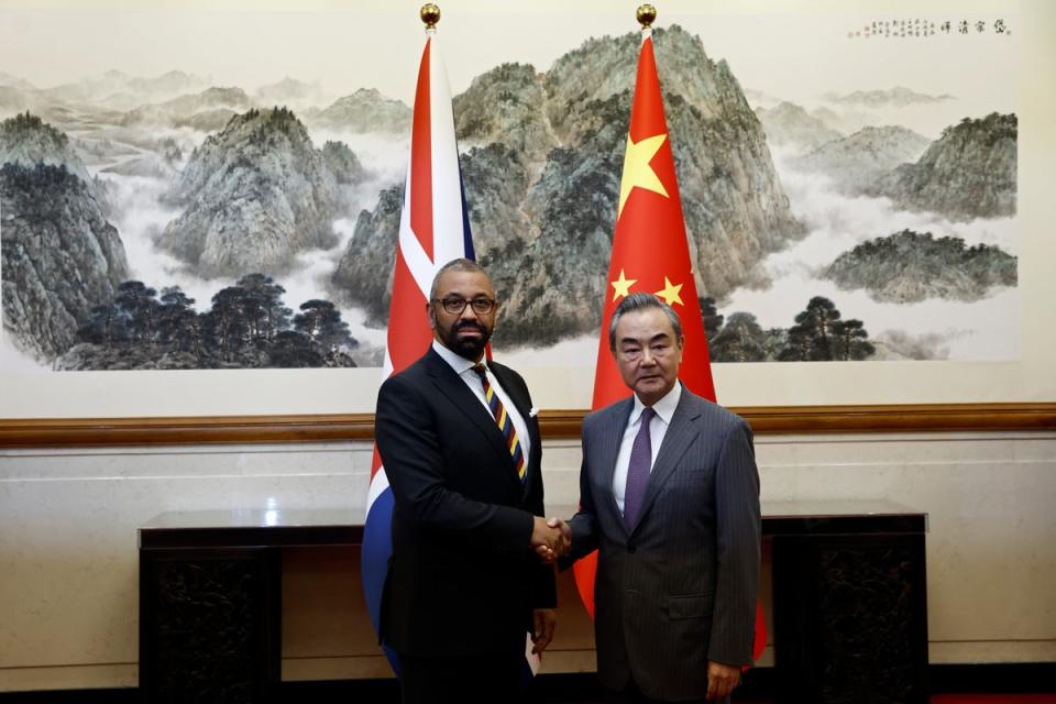British foreign secretary James Cleverly with Chinese foreign minister Wang Yi in August this year (AP)