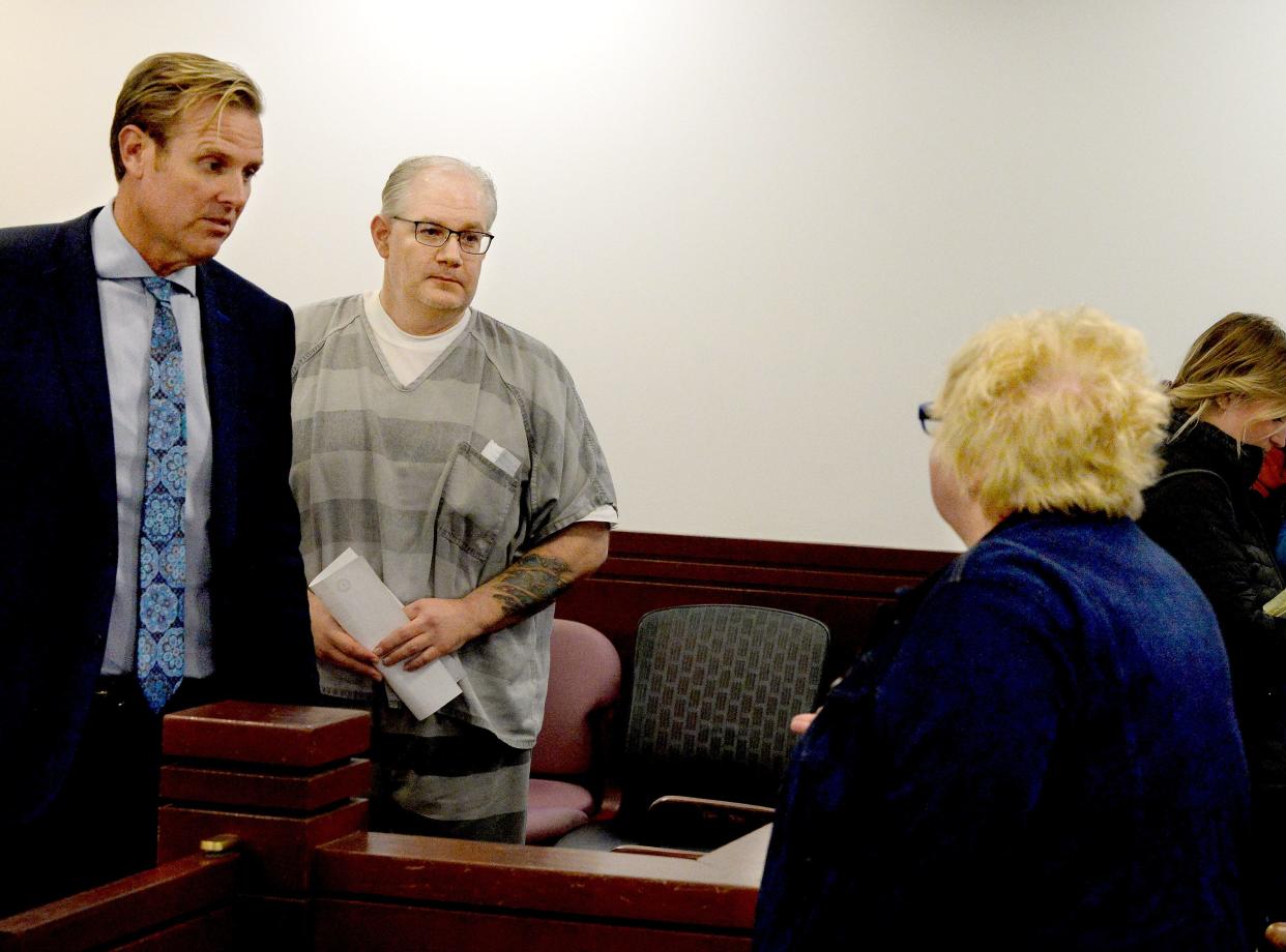 Peter Cadigan, center, stands next to his lawyer, Justin Kuehn, left, as he talks to his mother, Mary Cadigan, after his successful pre-trial release motion Monday, Oct. 30, 2023. Cadigan faces first-degree murder in the Dec. 18 death of Earl L. Moore Jr. of Springfield.