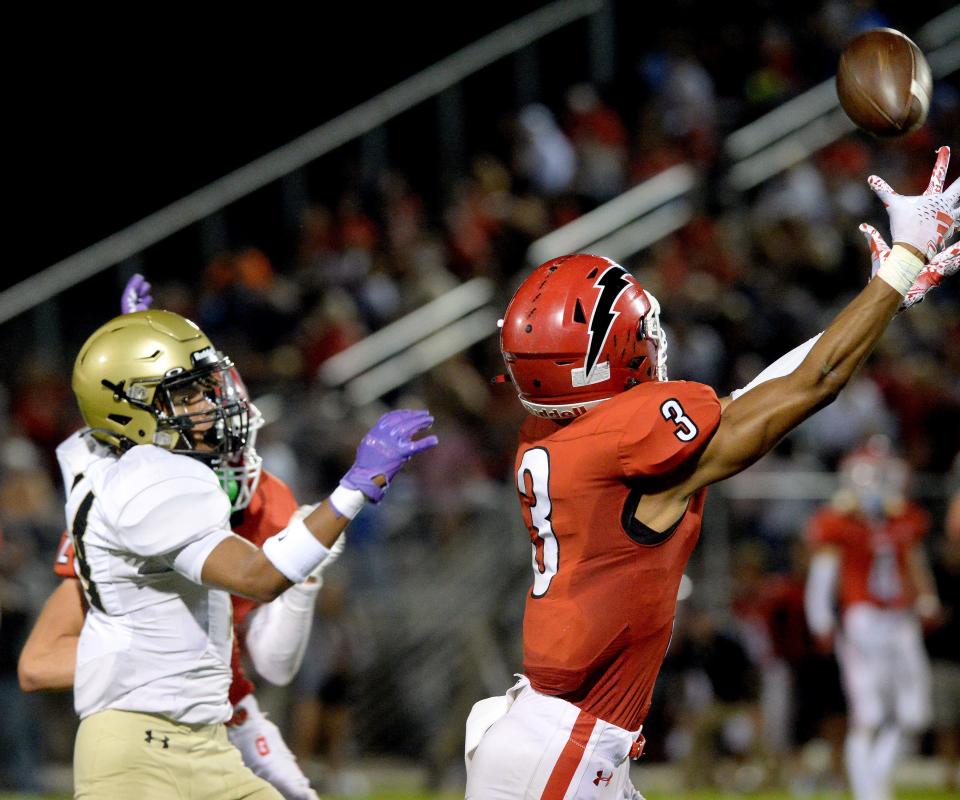 Glenwood High School's Jack Dettro, right, makes in interception against Sacred Heart-Griffin during the game Friday, Sept 29, 2023.