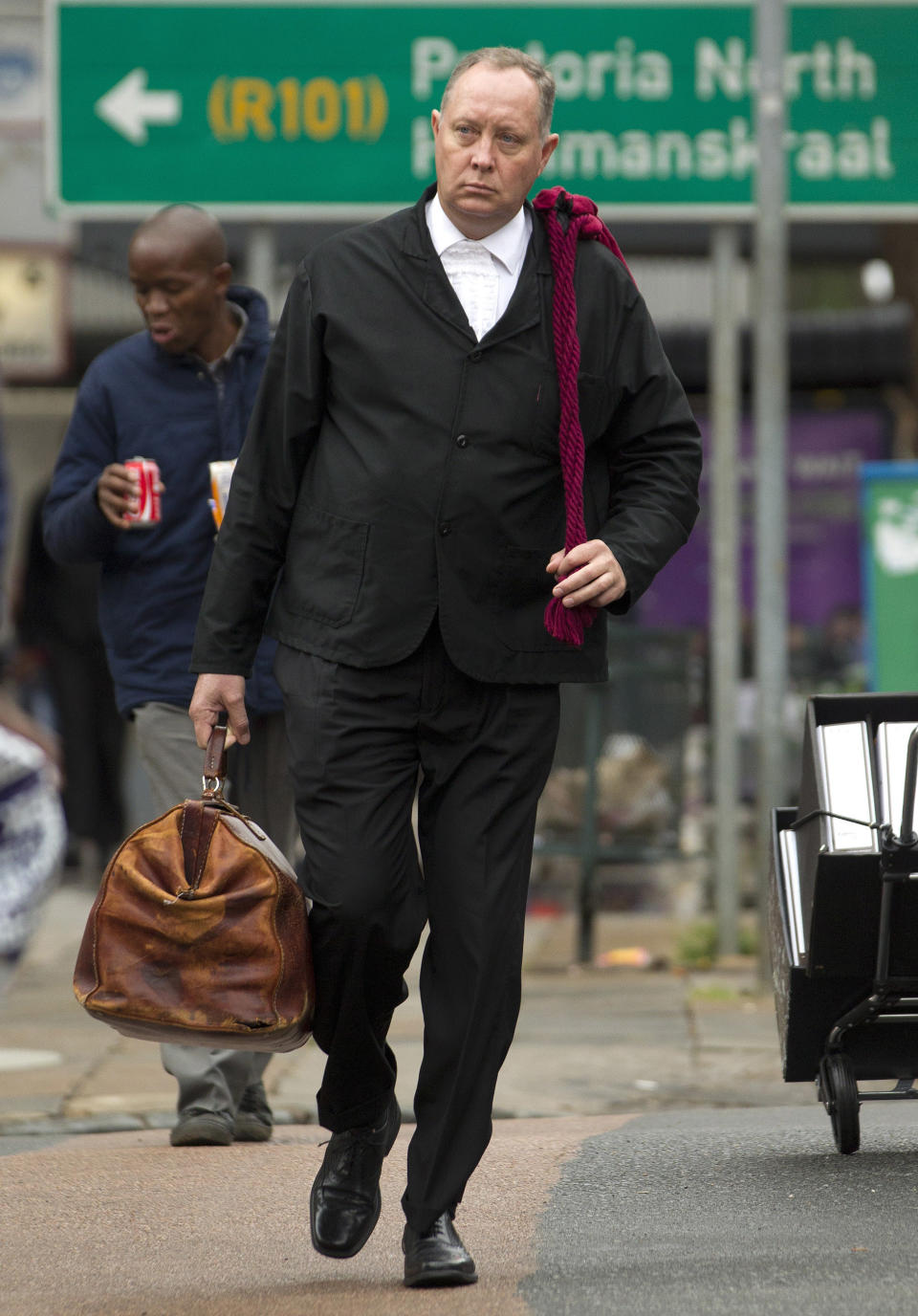 Kenny Oldwage, the lawyer defending Oscar Pistorius, arrives at the high court in Pretoria, South Africa, Tuesday, March 11, 2014. Pistorius is charged with murder for the shooting death of his girlfriend, Reeva Steenkamp, on Valentines Day in 2013. (AP Photo/Themba Hadebe)