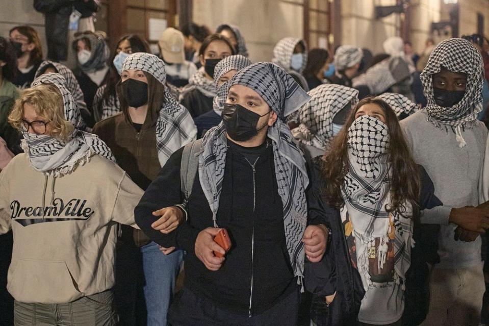 Pro-Palestinian student protestors block Hamilton Hall as they take over the interior of the building on Columbia University campus during an encampment calling for the university to divest from Israel, on April 29, 2024.<span class="copyright">Andres Kudacki for TIME</span>