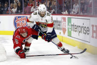 Florida Panthers' Matthew Tkachuk (19) protects the puck from Carolina Hurricanes' Brady Skjei (76) during the fourth overtime in Game 1 of the NHL hockey Stanley Cup Eastern Conference finals in Raleigh, N.C., early Friday, May 19, 2023. (AP Photo/Karl B DeBlaker)