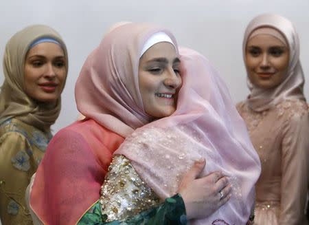 Aishat Kadyrova (L), head of the Firdaws fashion house and daughter of the Chechen Republic leader Ramzan Kadyrov, embraces a participant during the Mercedes-Benz Fashion Week Russia in Moscow, Russia, March 17, 2017. REUTERS/Sergei Karpukhin
