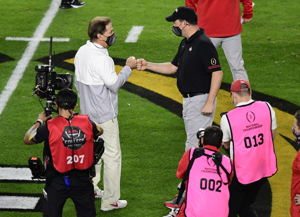 Jan 11, 2021; Miami Gardens, FL, USA; Alabama Crimson Tide head coach Nick Saban (left) greets Ohio State Buckeyes head coach Ryan Day before the 2021 College Football Playoff National Championship Game at Hard Rock Stadium. Mandatory Credit: Douglas DeFelice-USA TODAY Sports