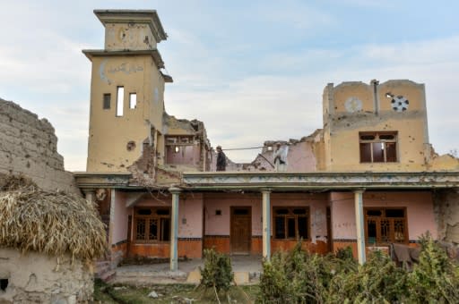 Residents walk amid the debris of their houses destroyed during fighting between Afghan security forces and the Islamic State group in their village in the Achin district of Nangarhar province