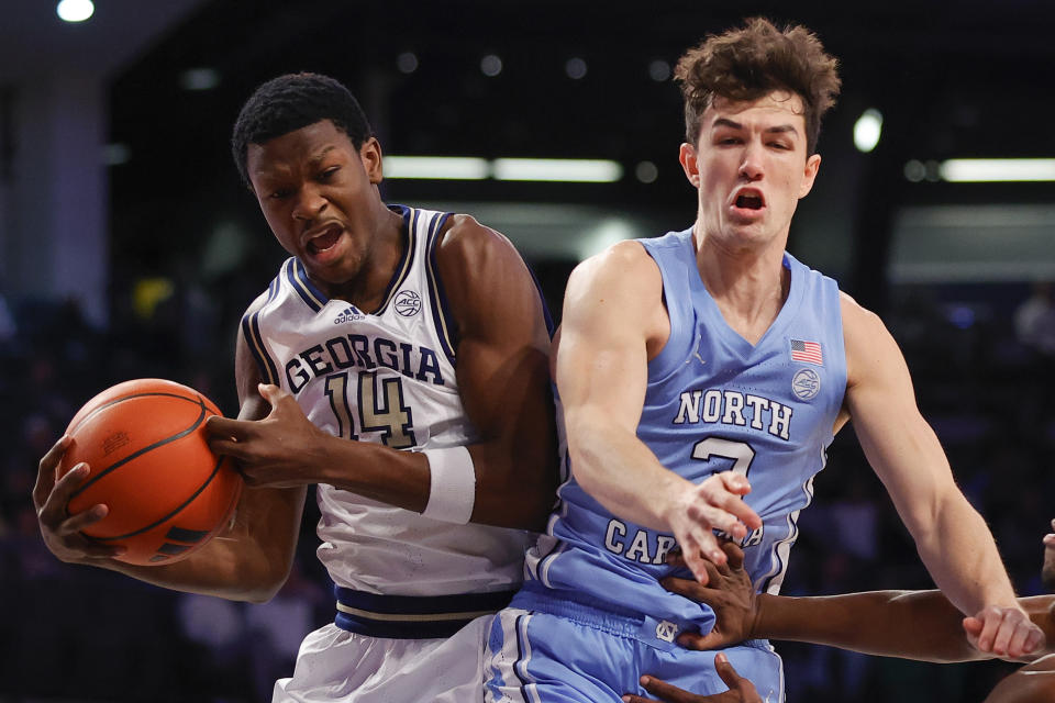 Georgia Tech guard Kowacie Reeves Jr. (14) rebounds the ball over North Carolina guard Cormac Ryan during the first half of an NCAA college basketball game Tuesday, Jan. 30, 2024, in Atlanta. (AP Photo/Alex Slitz)