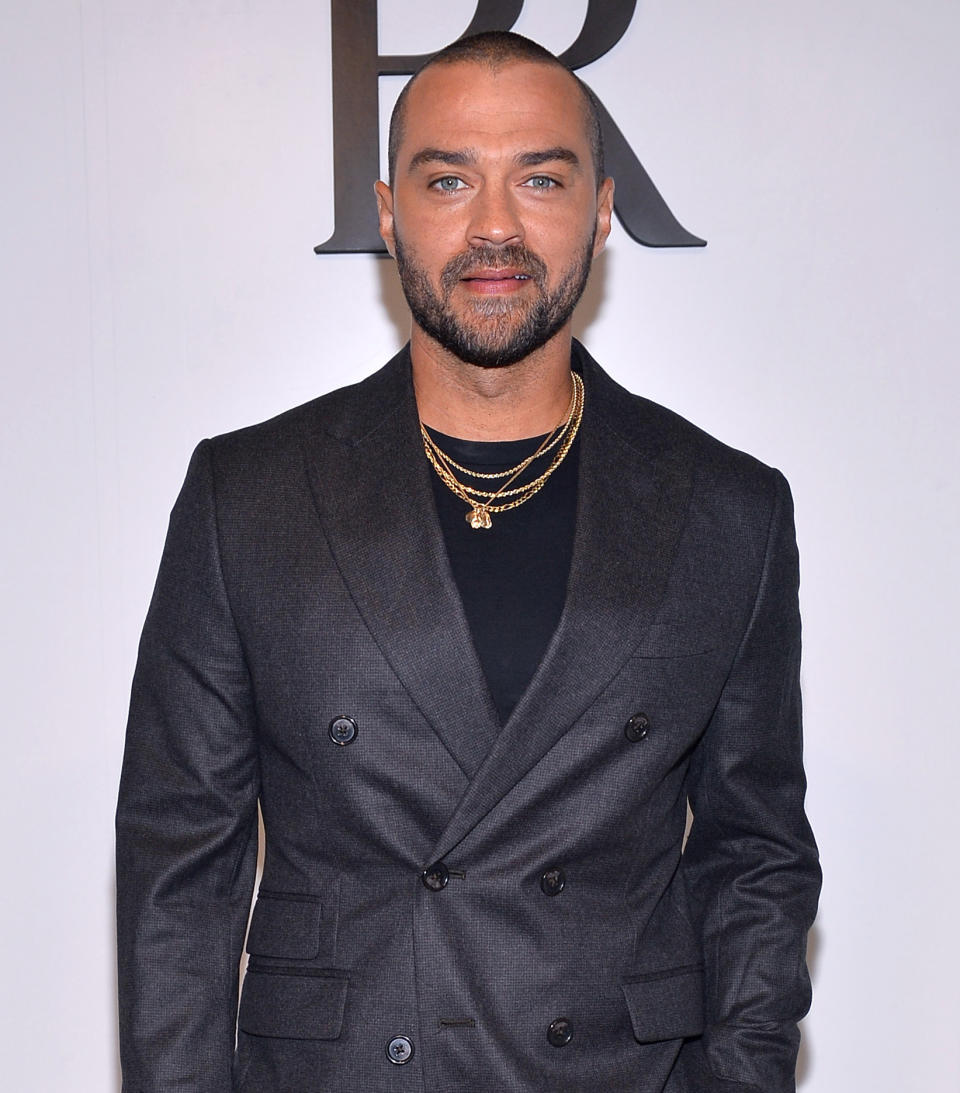 closeup of him in a suit with gold necklaces