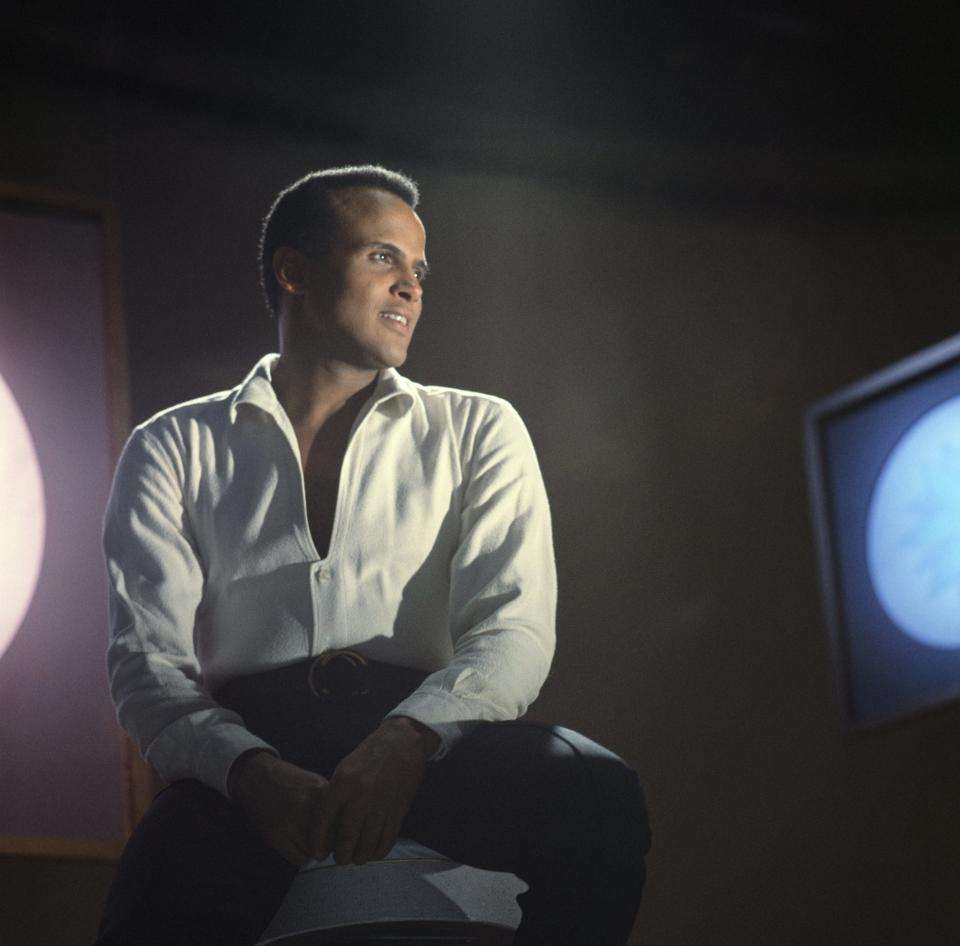 Harry Belafonte sitting on a chair