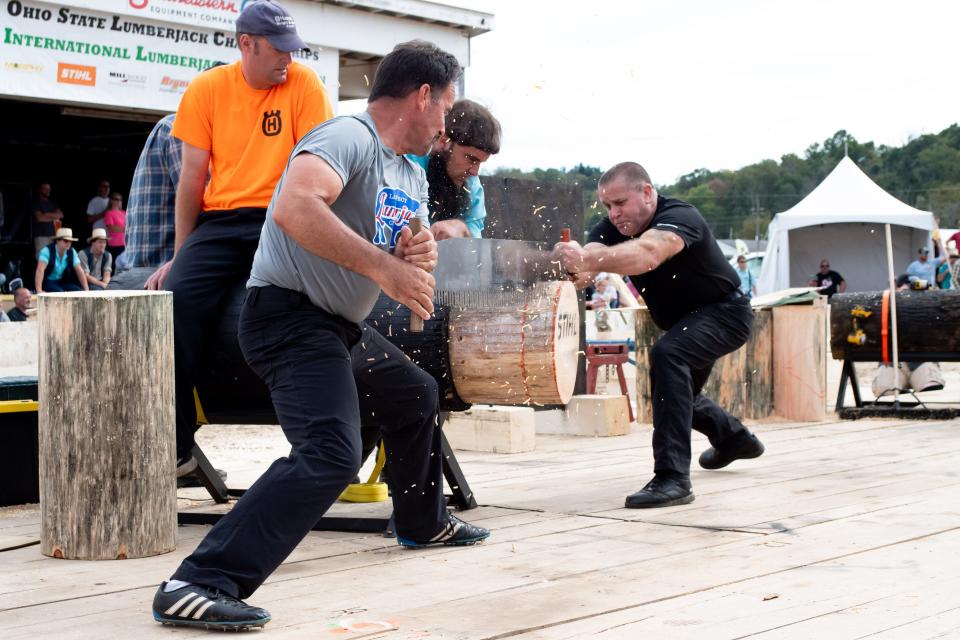 Mike 'Sully' Sullivan and Richard Jordan slice through a log during the crosscut saw competition at the 2021 Paul Bunyan Show International Lumberjack Competition.