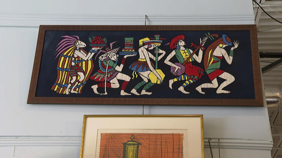 FILE - In this image from video, modern art depicting Native Americans belonging to the late Justice Ruth Bader Ginsburg, is seen inside Potomack Company Auctions in Alexandria, Va., Monday, April 11, 2022. An online auction of 150 of items owned by Ginsburg raised $803,650 for Washington National Opera. The opera was one of the late justice’s passions. (AP Photo/Nathan Ellgren, File)