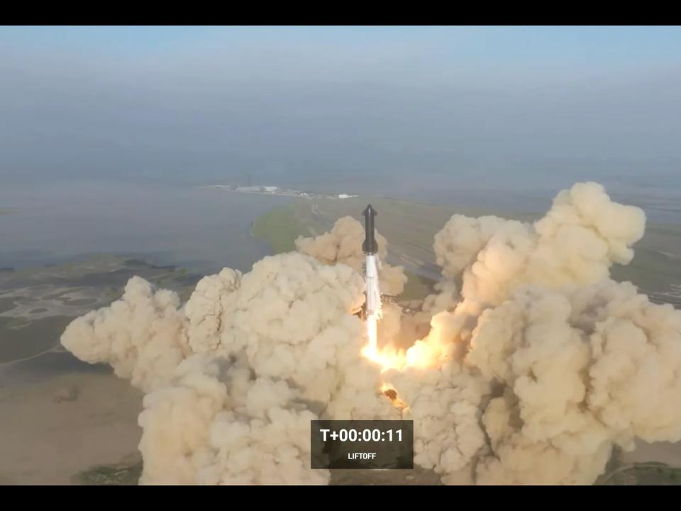 Starship black rocket lifts off from texas plains