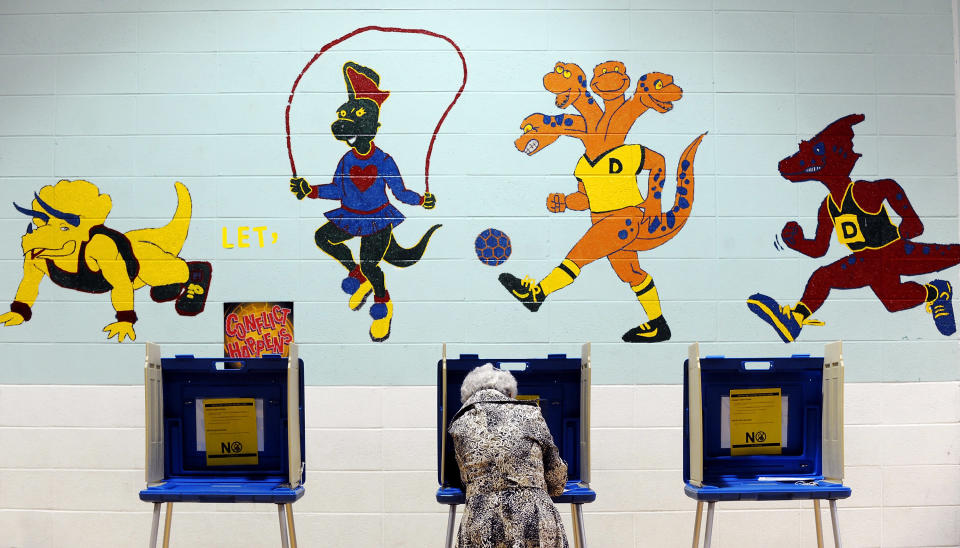 A voter casts her ballot in the gymnasium of Douglas Elementary School on November 6, 2012 in Raleigh, North Carolina. Early voting across North Carolina saw high numbers in early turn-out. As Americans go to vote, U.S. President Barack Obama and Republican presidential candidate Mitt Romney are in a virtual tie in the national polls. (Photo by Sara D. Davis/Getty Images)