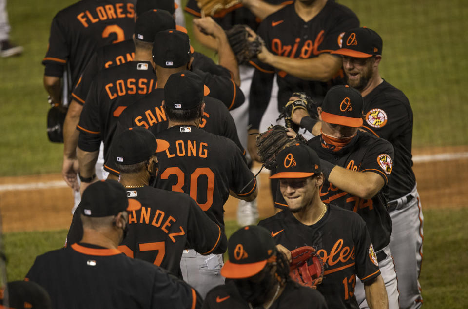 The Baltimore Orioles celebrate a baseball game victory over the Washington Nationals in Washington, Friday, Aug. 7, 2020. (AP Photo/Manuel Balce Ceneta)