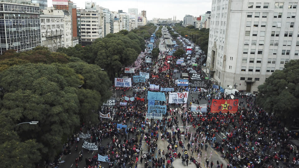 People march along the 9 de Julio Avenue to demand better wages and jobs, in Buenos Aires, Argentina, Friday, June 18, 2021. In the midst of a second wave of the new coronavirus, healthcare workers and social organizations marched due to high inflation and increasing poverty. (AP Photo/Victor R. Caivano)