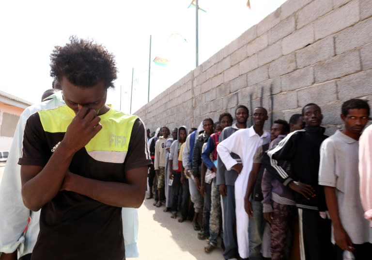 Migrants rescued by the Libyan coastguard at sea wait in a naval base near the capital Tripoli on October 8, 2015