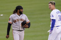 San Francisco Giants starting pitcher Johnny Cueto, left, briefly talks with Los Angeles Dodgers' Joc Pederson after Pederson flew out to end the third inning of a baseball game Saturday, Aug. 8, 2020, in Los Angeles. (AP Photo/Mark J. Terrill)