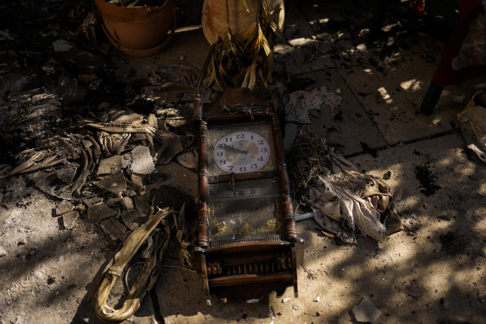 A damaged clock outside a home that came under attack during a massive Hamas invasion into Kibbutz Nir Oz, Israel, Thursday, Oct. 19, 2023. The small farming community in the south of Israel was overrun by Hamas fighters from the nearby Gaza Strip who killed 1,400 Israelis and captured dozens of others on Oct. 7. (AP Photo/Francisco Seco)