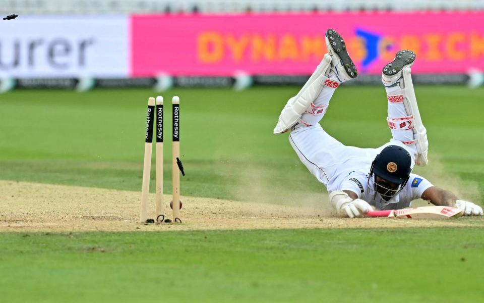 Bails fly as the ball, thrown by England's Ollie Pope (unseen), hits the stumps to run out Sri Lanka's Lahiru Kumara