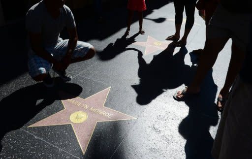 A woman and child holding hands approach the Marilyn Monroe Star along Hollywood's Walk of Fame on Hollywood Boulevard on July 28. The buxom beauty died 50 years ago, from an overdose of sleeping pills, at just 36 years old