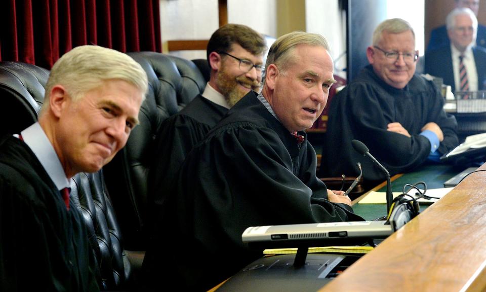 Joseph Michael, second from left, speaks after being sworn in as associate judge of the Circuit Court of Washington County during a ceremony Friday in the old courthouse in Hagerstown.