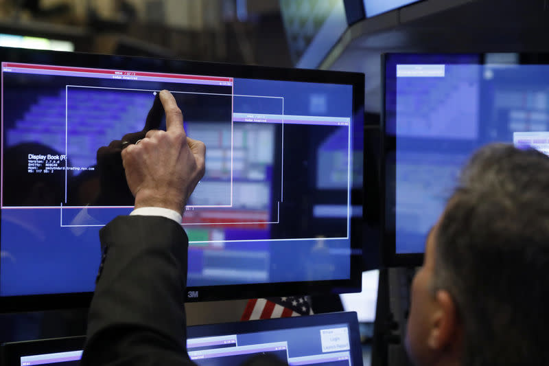 A trader works on the floor of the New York Stock Exchange (NYSE) shortly after the opening bell in New York, U.S., January 13, 2017. REUTERS/Lucas Jackson