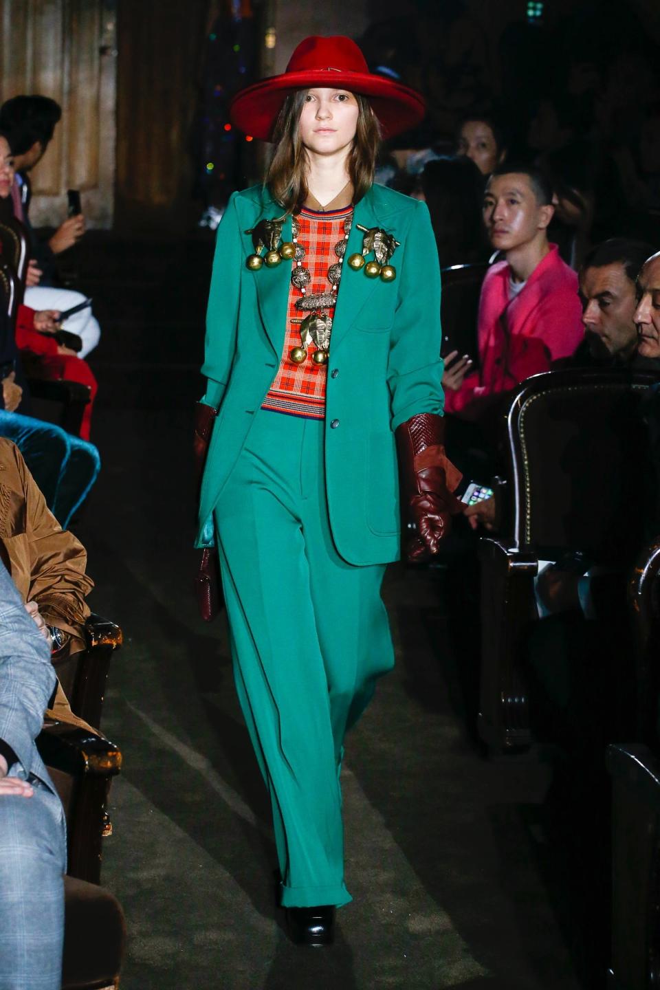 Gucci’s Spring 2019 emerald suit, with a kitschy sweater-vest and embellishments, take a boardroom classic into evening.