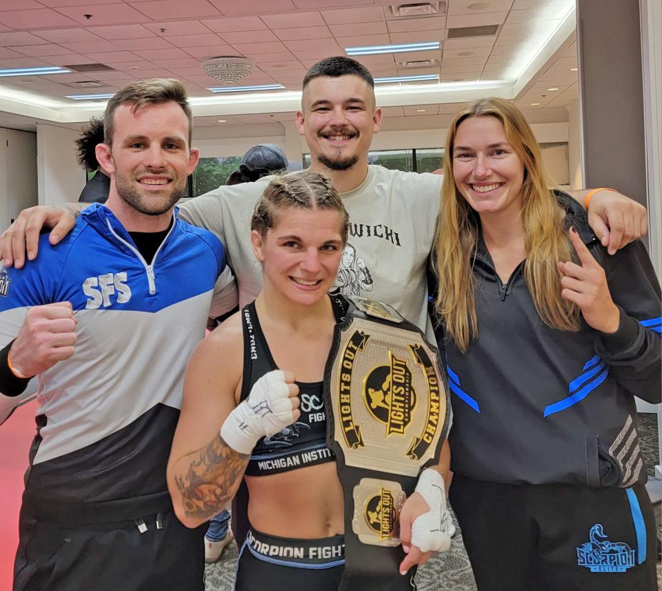 Coldwater alumni Zoe Nowicki, shown here with her coaches at Scorpion Fighting Systems, won her first MMA title this past Saturday, winning the Lights Out Flyweight championship via an arm bar submission