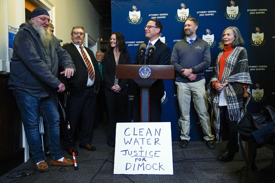 Pennsylvania Attorney General Josh Shapiro, center, speaks with members of the media during a news conference at the Susquehanna County District Courthouse in Montrose, Pa., Tuesday, Nov. 29, 2022. Pennsylvania's most active gas driller has pleaded no contest to criminal environmental charges in a landmark pollution case. Houston-based Coterra Energy Inc. entered its plea Tuesday. (AP Photo/Matt Rourke)