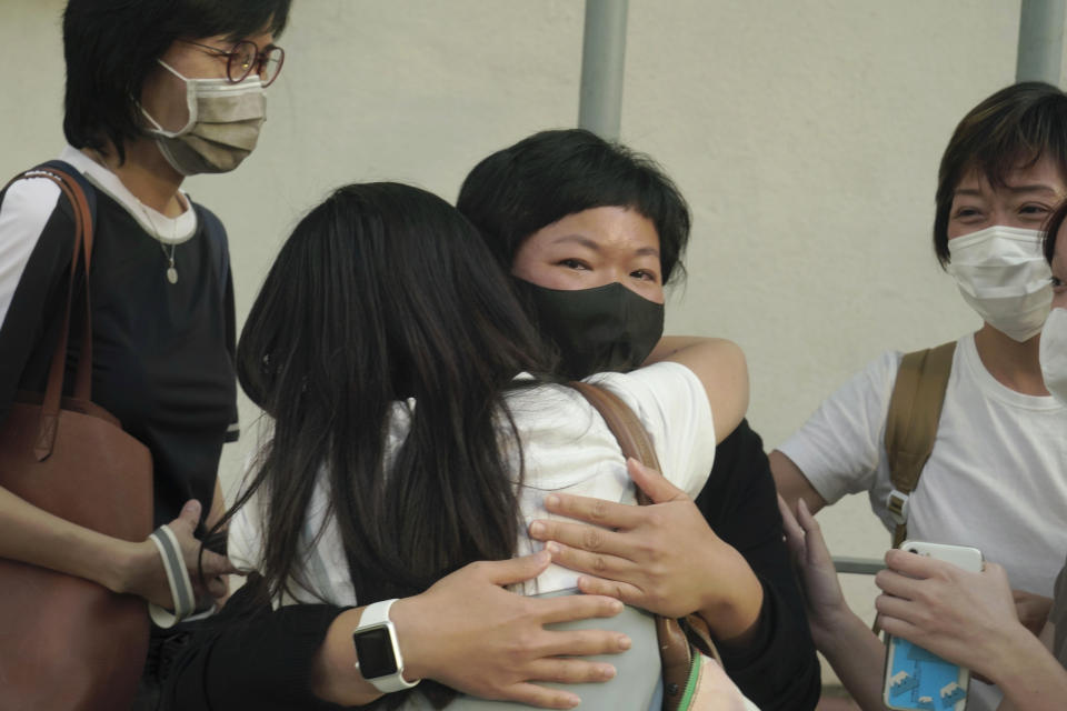 Hong Kong journalist Choy Yuk-ling, center, also known as Bao Choy, reacts outside a court in Hong Kong Thursday, April 22, 2021. The Hong Kong journalist was fined 6,000 Hong Kong dollars ($775) on Thursday after being found guilty of making false statements while obtaining information from a vehicle database, in the latest blow to press freedom in the city as authorities continue their crackdown on dissent. (AP Photo/Kin Cheung)